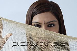 PictureIndia - Young woman hiding behind veil