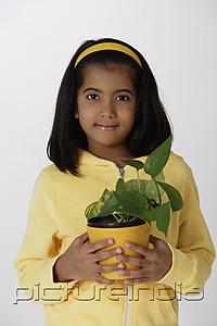 PictureIndia - Girl holding plant