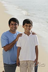 PictureIndia - Father holding son's shoulders and smiling