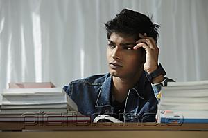 PictureIndia - young man reading book and thinking