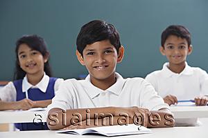 Asia Images Group - three students smiling at camera, boy in center