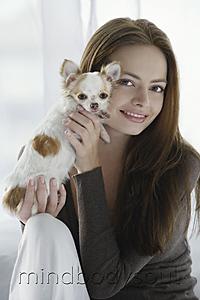 Mind Body Soul - Young woman holding chihuahua