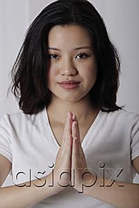 AsiaPix - Pregnant woman standing in prayer posture
