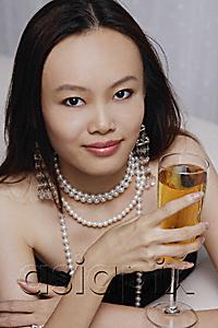 AsiaPix - Young woman holding glass of champagne