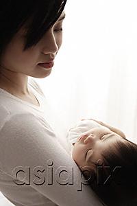AsiaPix - Woman holding sleeping baby