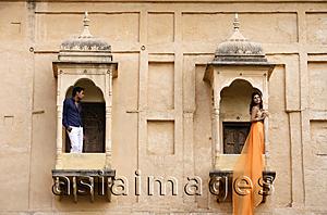 Asia Images Group - man and woman on balconies, woman in sari