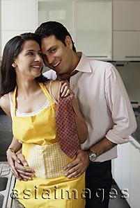Asia Images Group - young couple sharing special moment in kitchen