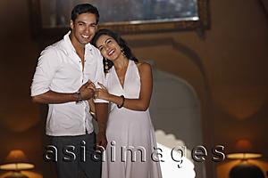 Asia Images Group - couple wearing white, embracing