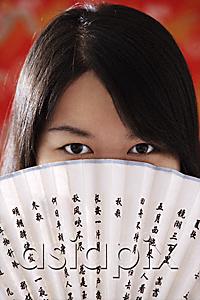 AsiaPix - Chinese woman looking over hand-held fan with Chinese characters
