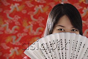 AsiaPix - Chinese woman looking over hand-held fan with Chinese characters