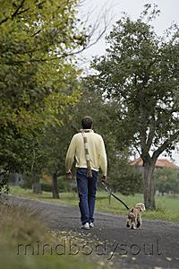 Mind Body Soul - Young man walking dog