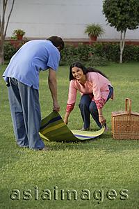 Asia Images Group - couple setting up picnic