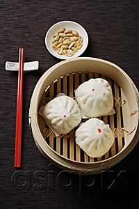 AsiaPix - Steamed buns in bamboo steamers with red chopsticks