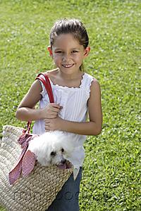 Mind Body Soul - young girl carrying white dog in basket