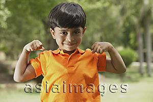 Asia Images Group - little boy flexing muscles