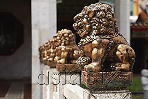 AsiaPix - Row of bronze statues in front of Buddhist temple.