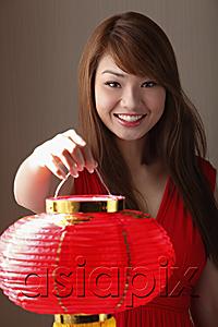 AsiaPix - Young woman holding red lantern and smiling