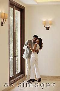 Asia Images Group - young couple dancing in new home