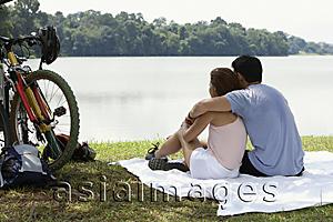 Asia Images Group - Couple sitting on blanket by a lake