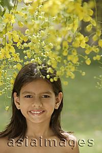 Asia Images Group - little girl under flowering tree