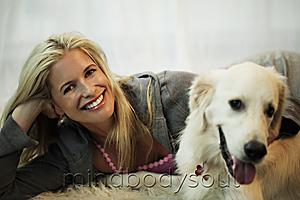 Mind Body Soul - blond woman playing with her dog