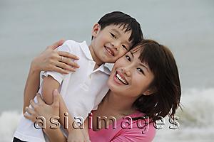 Asia Images Group - young woman and boy cheek to cheek