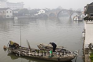 Asia Images Group - A man cleaning his boat in the morning,  Zhujiajiao, China