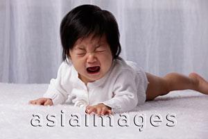 Asia Images Group - Chinese baby on tummy crying