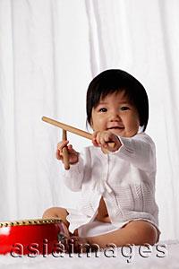 Asia Images Group - Chinese baby with red drum holding drum sticks