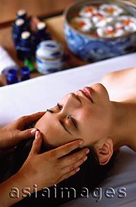 Asia Images Group - Eurasian female lying down receiving a head massage