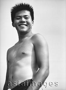 Asia Images Group - Teenage boy in swimsuit smiling, portrait, low angle view