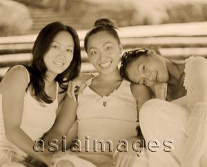 Asia Images Group - Three women wearing white, sitting together