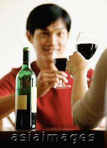 Asia Images Group - Man drinking wine with friend