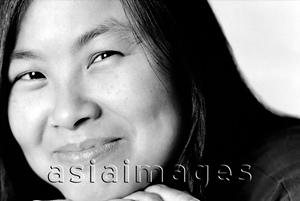 Asia Images Group - Young woman with hand on chin, smiling
