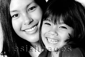 Asia Images Group - Young woman embracing young girl