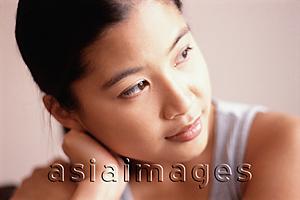 Asia Images Group - Young woman, hand on head, looking away.