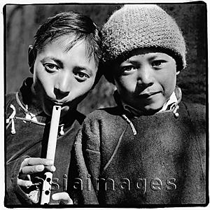 Asia Images Group - India, Northern India, Srinagar-Leh Road, Portrait of two young boys, one playing recorder.