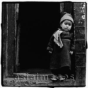 Asia Images Group - India, Ladakh, Portrait of little boy standing in doorway.