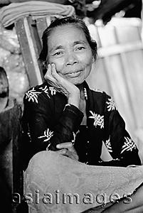 Asia Images Group - Indonesia, Java, Portrait of lady resting head on hand, smiling.