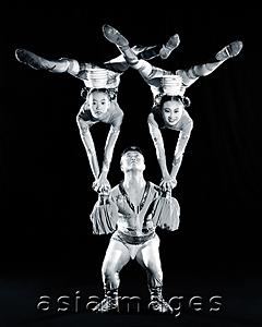 Asia Images Group - China, Hong Kong, Acrobats of the Shenyang Acrobatic Troupe performing balancing act with bowls