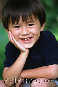 Asia Images Group - Young boy smiling with hand on chin