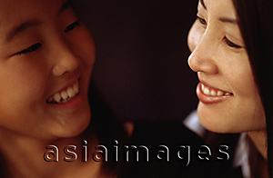Asia Images Group - Mother and daughter looking at each other and smiling