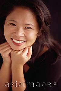 Asia Images Group - Woman smiling with chin on hands