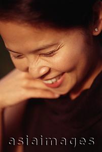 Asia Images Group - Woman looking down and smiling