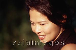 Asia Images Group - Woman looking down and smiling