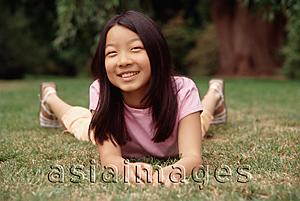 Asia Images Group - Girl lying on grass