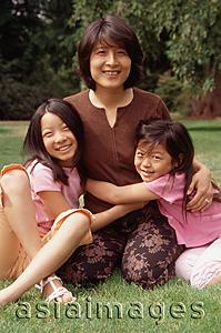 Asia Images Group - Mother with two daughters, looking at camera
