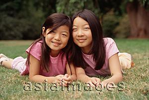 Asia Images Group - Two sisters lying on grass