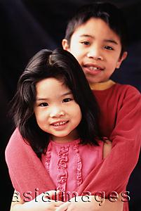 Asia Images Group - Brother and sister hugging.