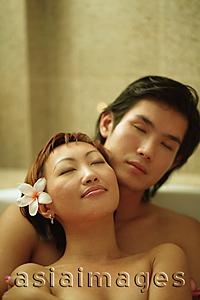 Asia Images Group - Couple embracing in tub, eyes closed